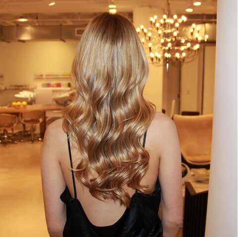 Blonde waves beneath the chandelier in the styling area at Red Market Miami